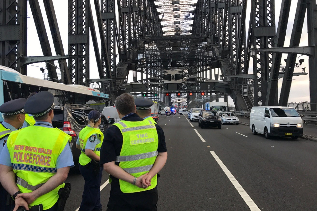 Police and emergency crews shut down Sydney Harbour Bridge.