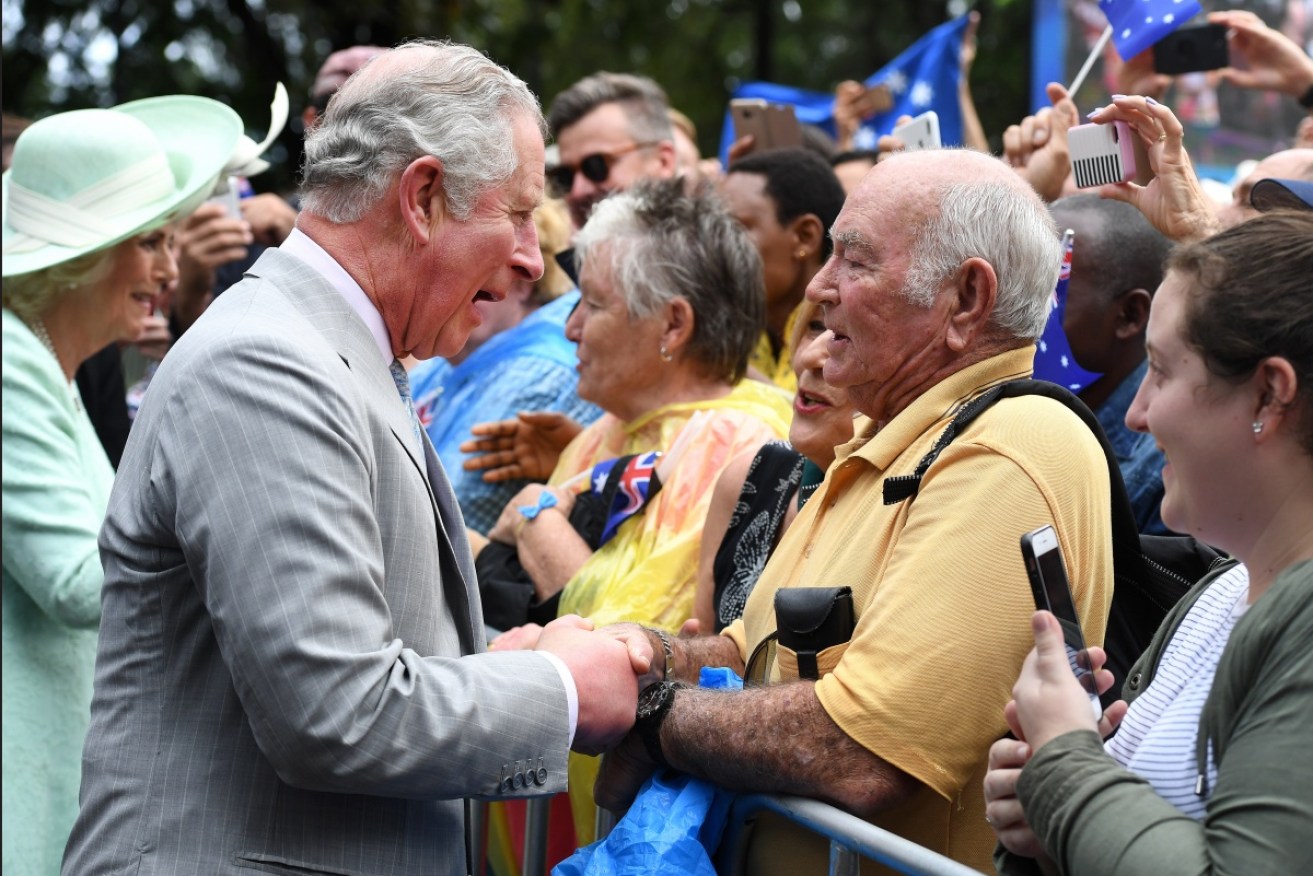 Prince Charles and the Duchess of Cornwall work the small but lively crowd at Brisbane's Botanic Gardens on Wednesday. 