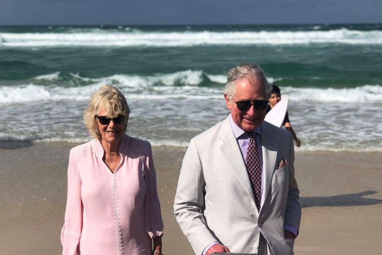 Prince Charles and Camilla take a stroll along Broadbeach during their official duties.