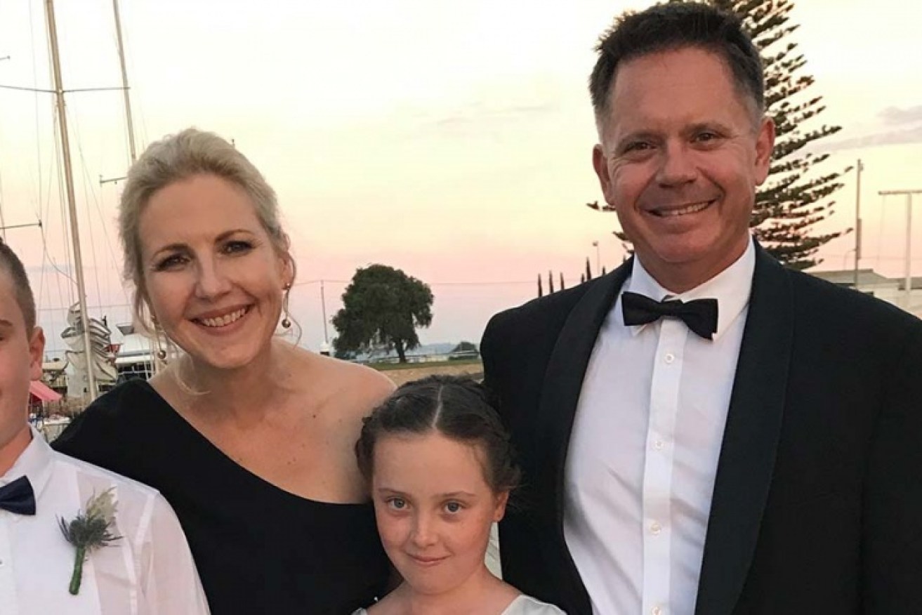 Tim Gibson with his children and wife Jo – who is now clear of cancer.