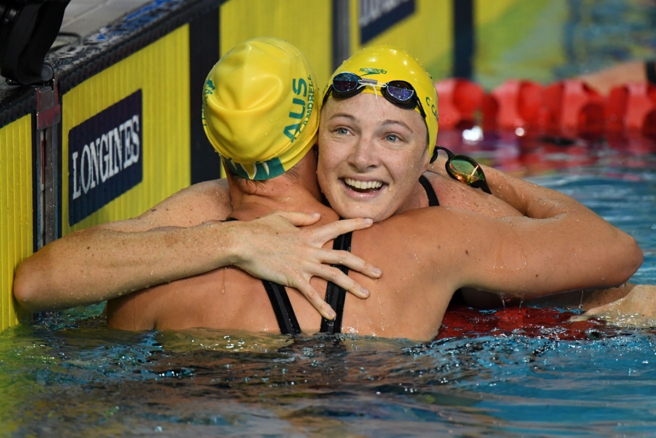 Cate Campbell hugs her younger sister, Bronte, after winning gold.