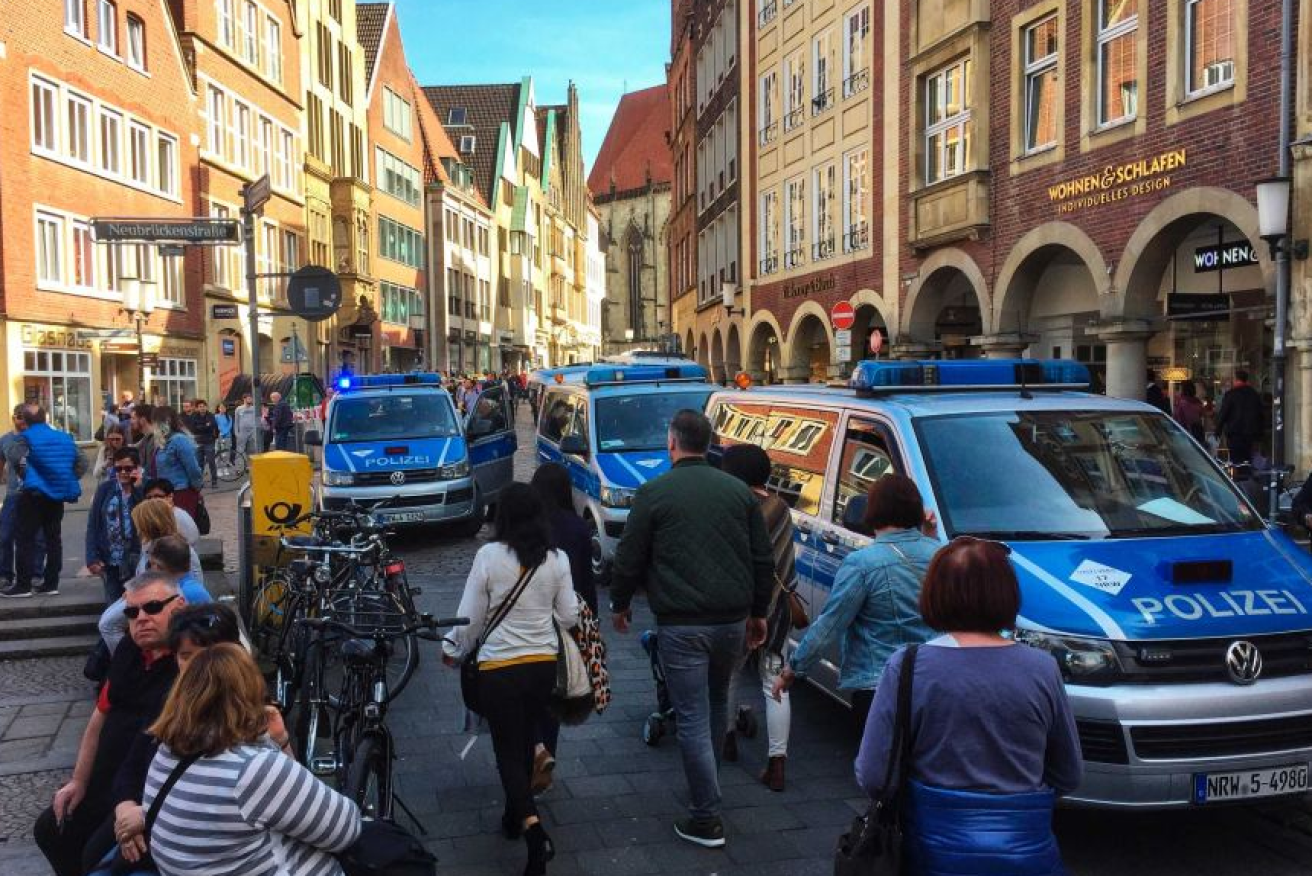 Police and emergency vehicles pack the  narrow streets of historic Muenster.