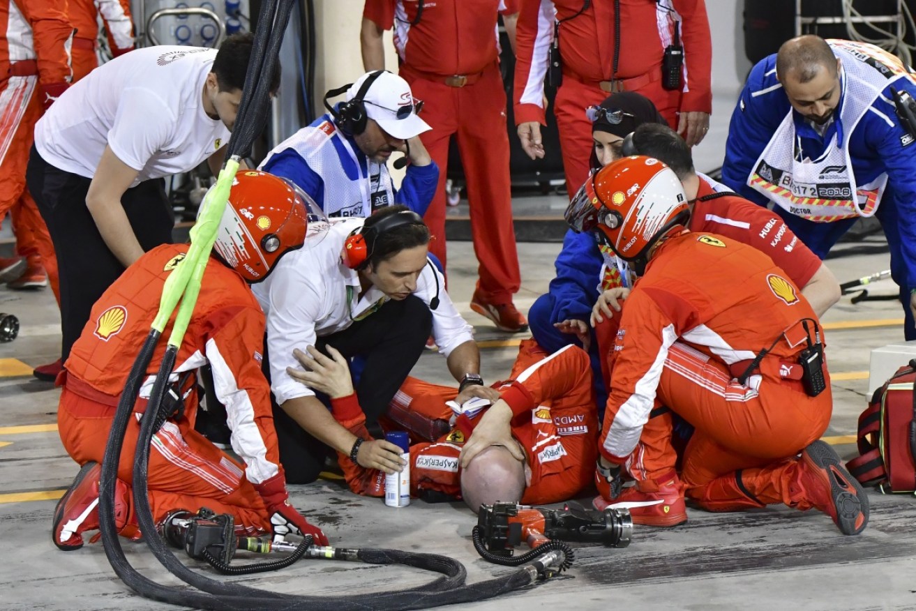 A Ferrari mechanic of is attended to after he was hit by Finnish Formula One driver Kimi Raikkonen.