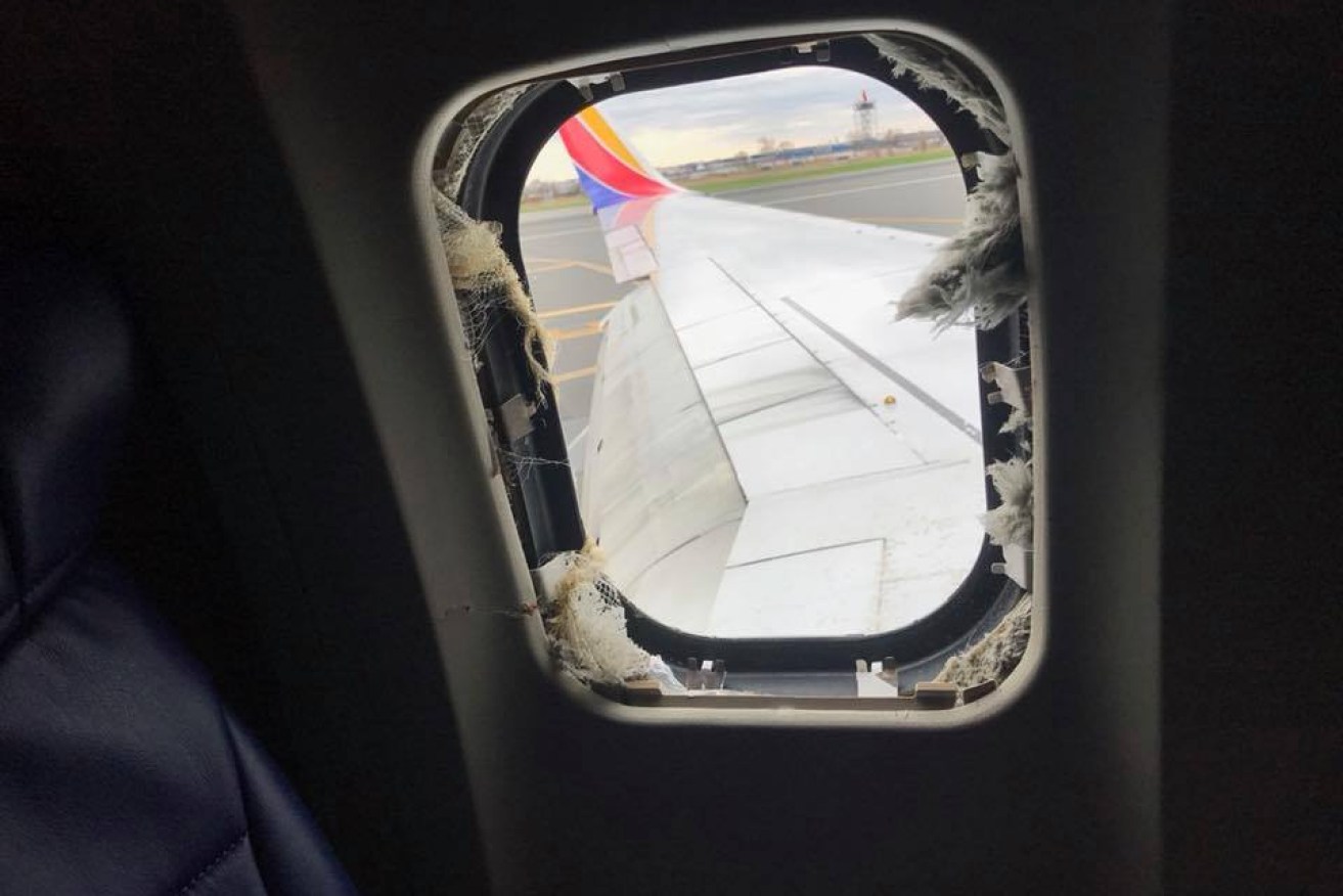 A blown out window taken from inside the Southwest Airlines plane.  