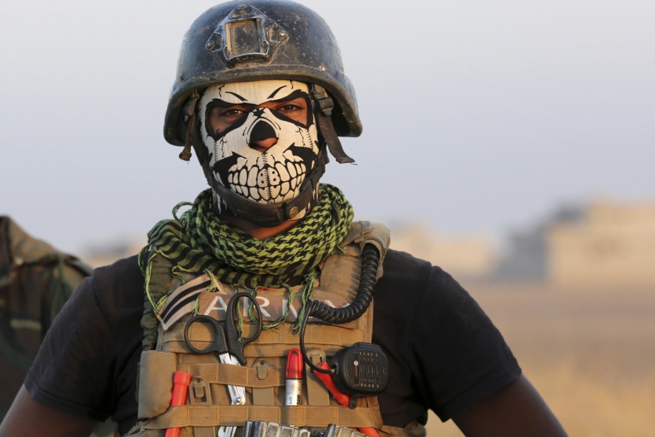 A member of Iraq's elite Special Forces wears a skull mask in the fight against the Islamic State in 2016