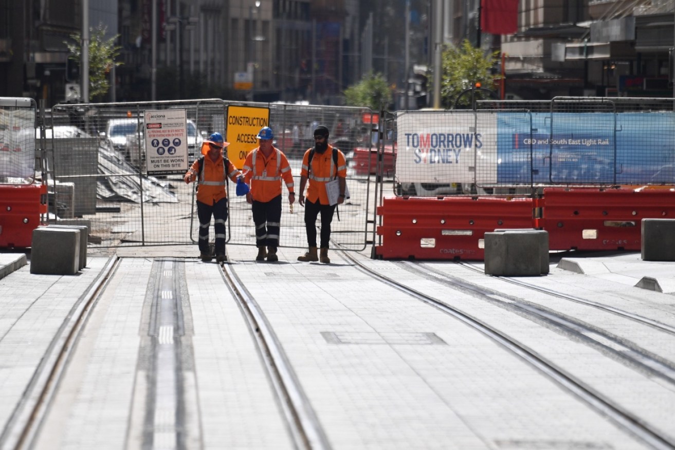 Workmen are pictured at the construction site on George Street last week.