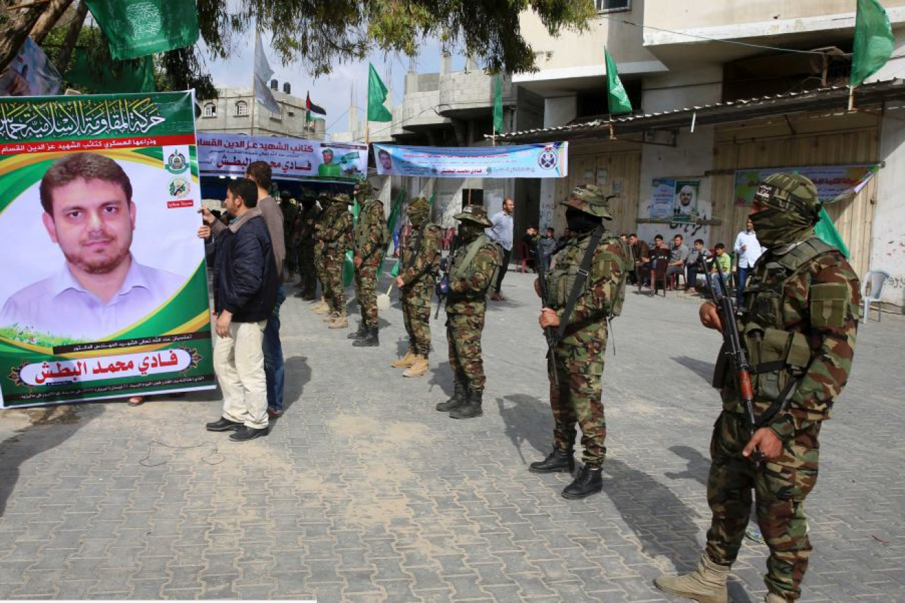 Masked Hamas fighters form a guard of honor at the Gaza memorial service for Fadi al-Batsh.