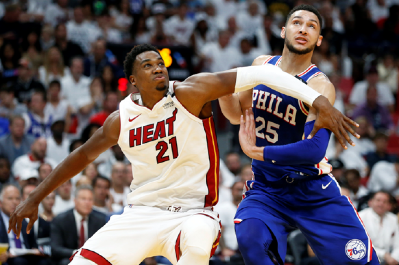 Australian superstar Ben Simmons (R)  jostles with Miami Heat star Hassan Whiteside (L) in his record-setting playoff performance.