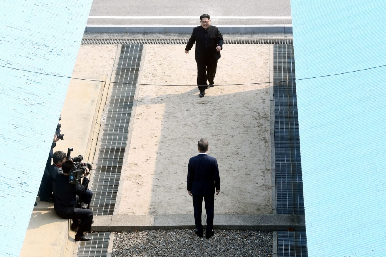 Kim Jong-un (top) has become first North Korean leader to cross the line dividing the two  countries since the Korean War ended.