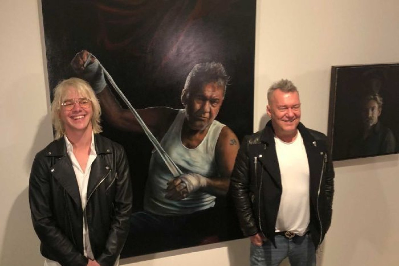 Jamie Preisz and Jimmy Barnes stand with the 'packing room prize' winning portrait.