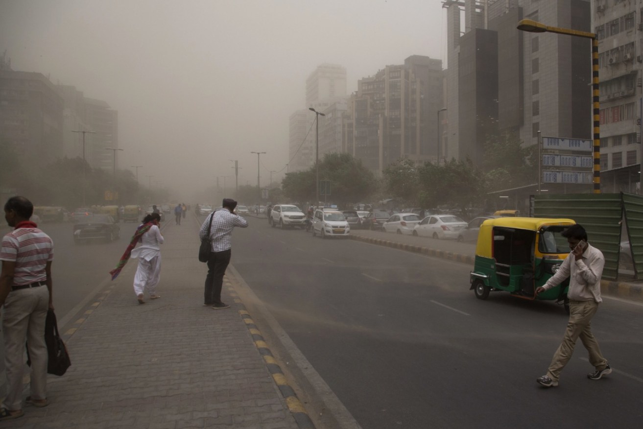 Residents in New Delhi are enveloped by dust rising from a storm in New Delhi, India on Wednesday, May 2.