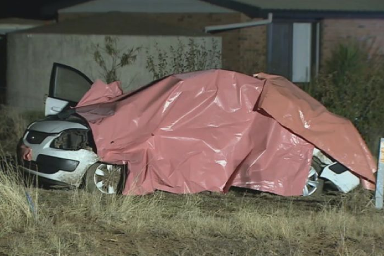 A tarp cannot conceal the shocking damage to the car in which four elderly women died.