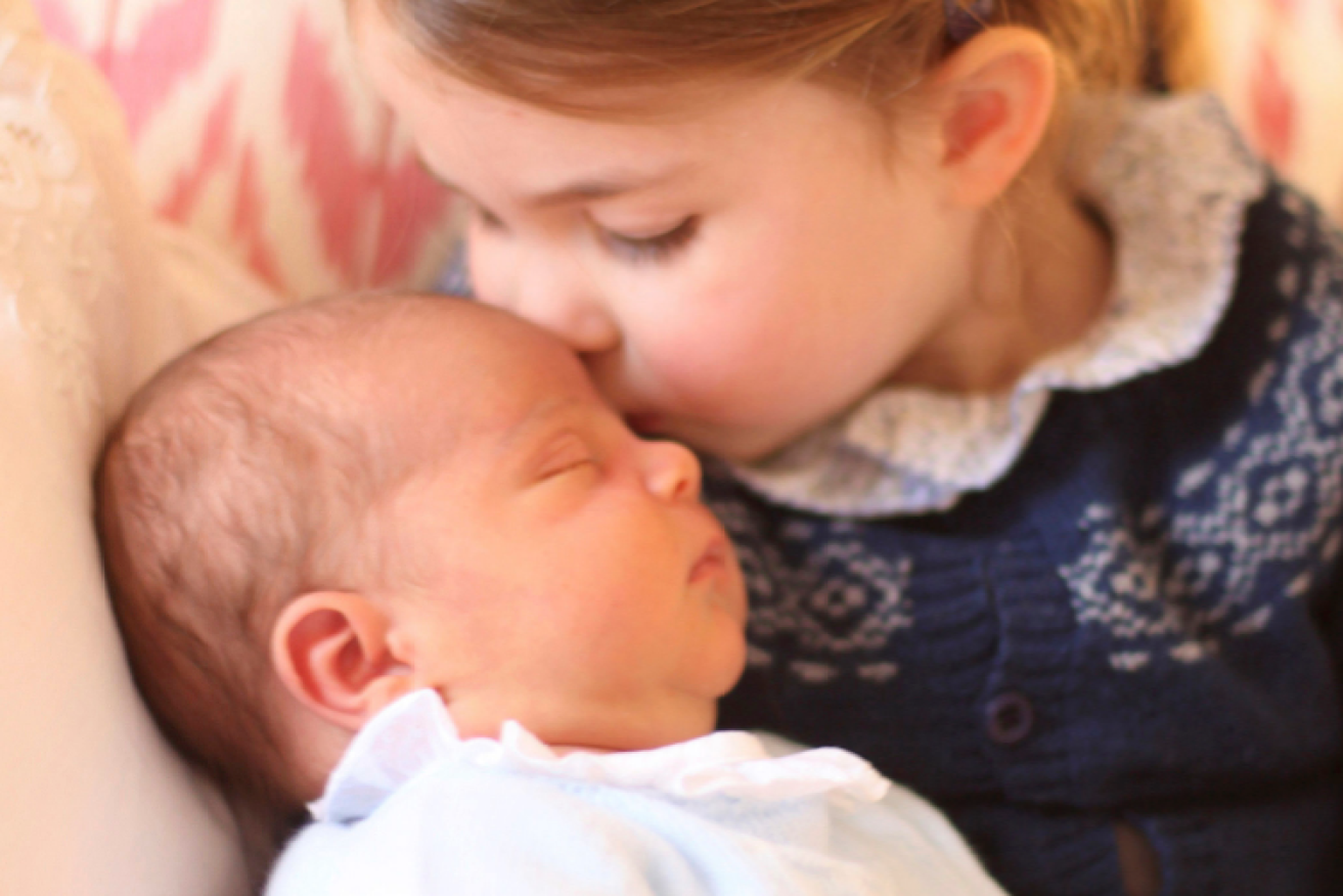 Princess Charlotte plants a kiss on the latest addition to royal ranks, three-day-old Prince Louis.