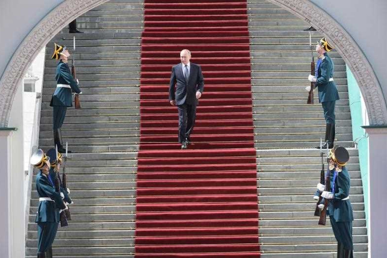 The Russian President's long march went through corridors, in a limousine, across cobblestones and down a red carpet.