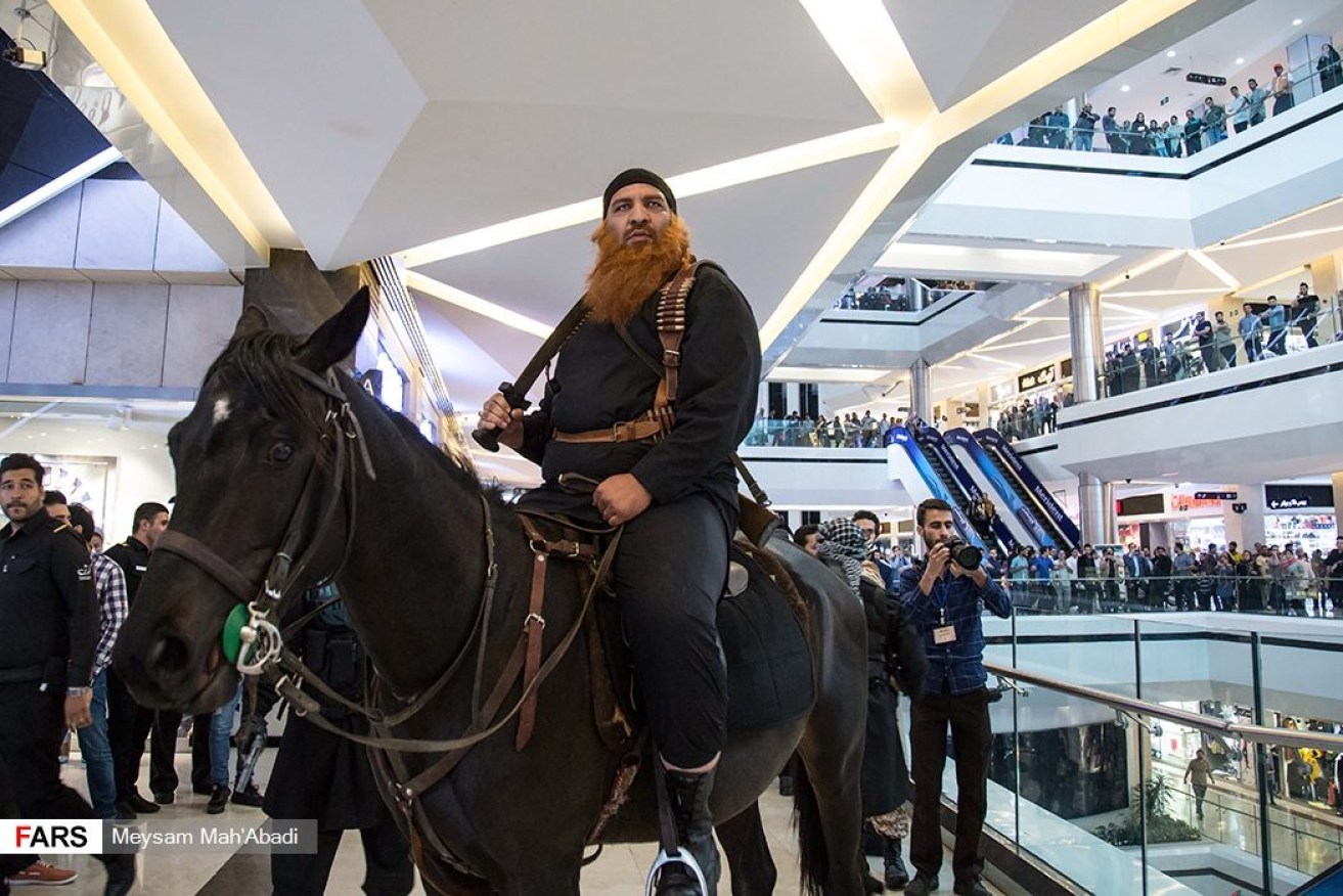 An actor on horseback in a Iranian shopping centre. 