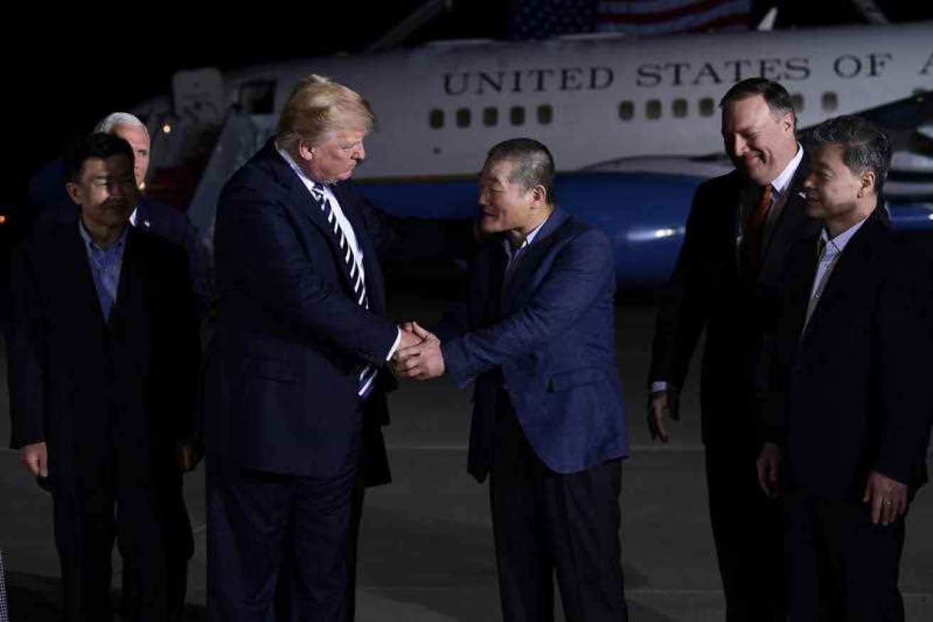 Donald Trump shakes hands with Kim Dong Chul upon the detained Americans' arrival at Andrews Air Force Base.