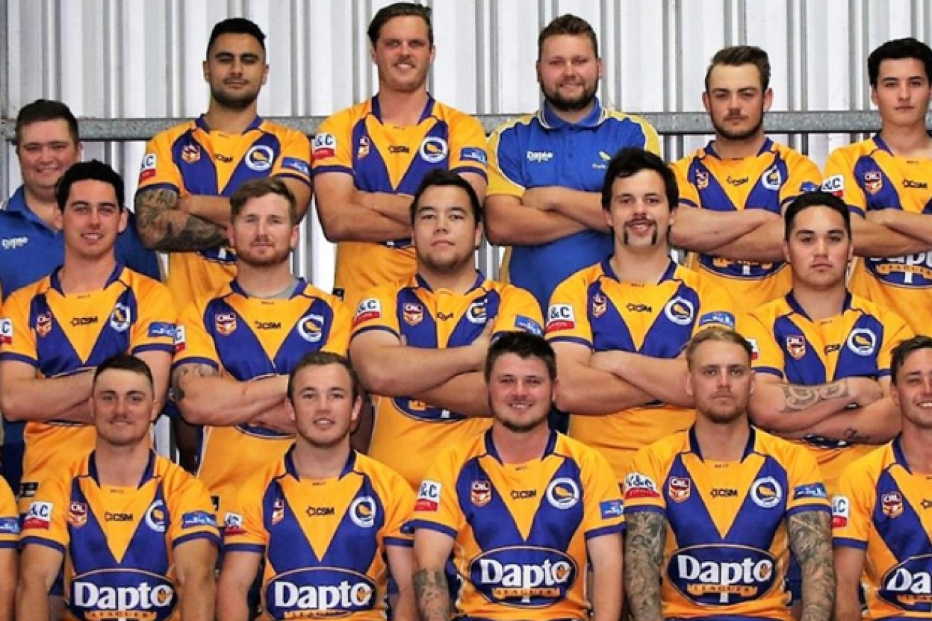 Tory Brunning, standing, centre row, with teammates.