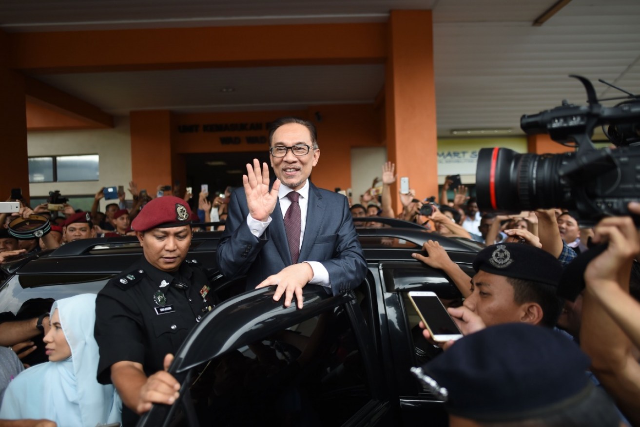 Anwar Ibrahim is mobbed as he leaves hospital.