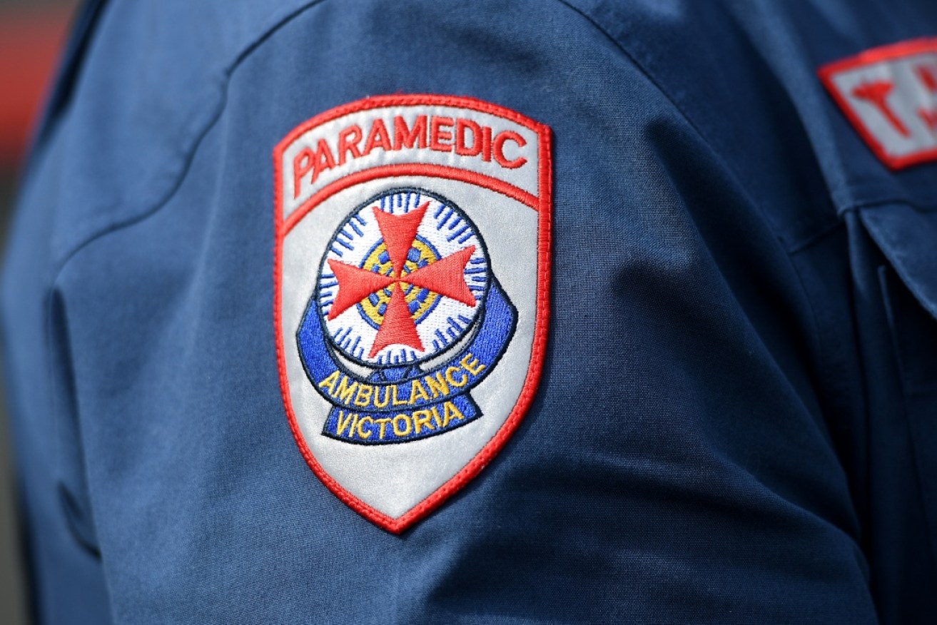 Ambulance crewpersons tried to revive the fallen rider without success. <i>Photo: AAP</i>