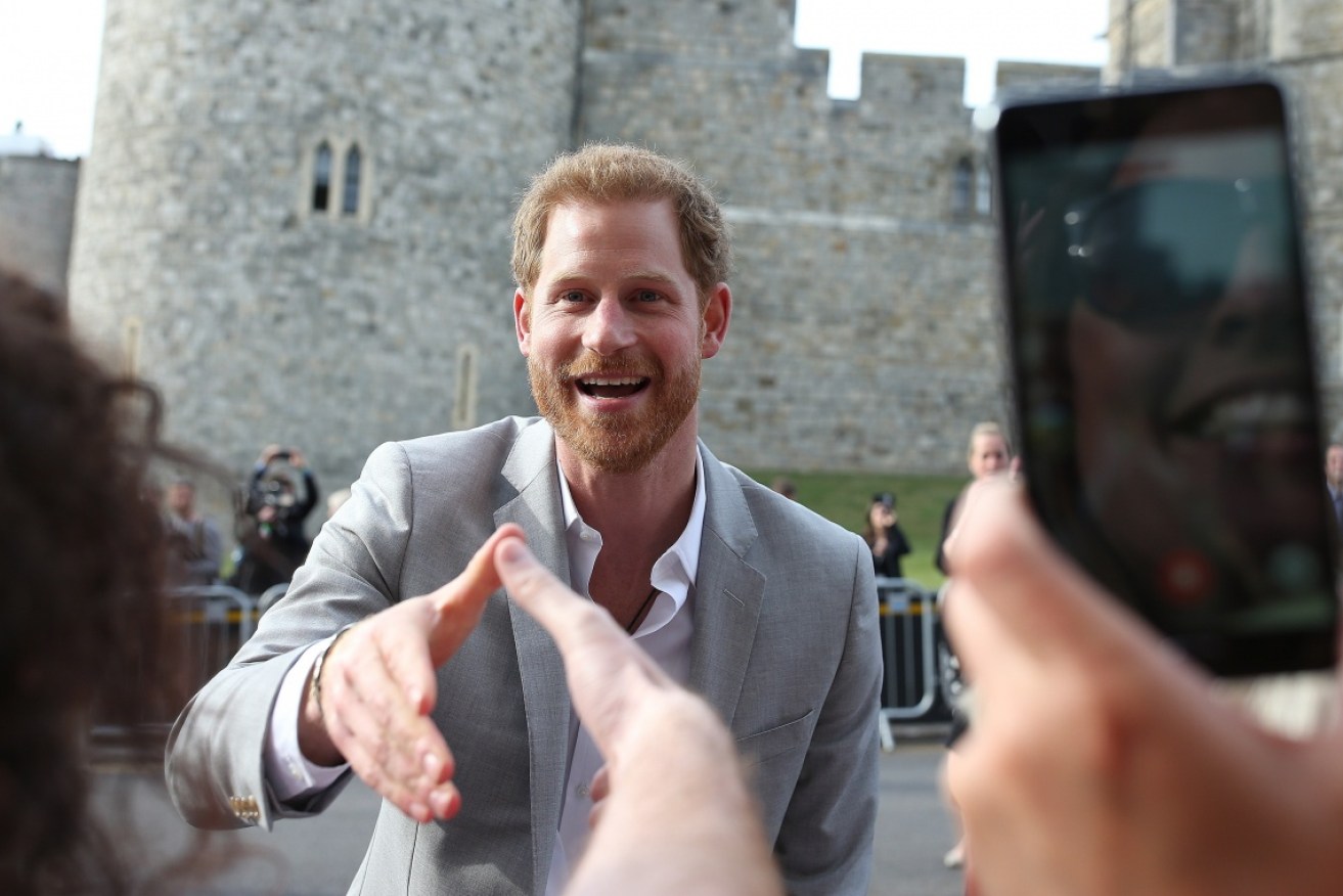 Harry went on a last-minute surprise walkabout in Windsor, chatting to local school children and even accepting a small teddy bear.