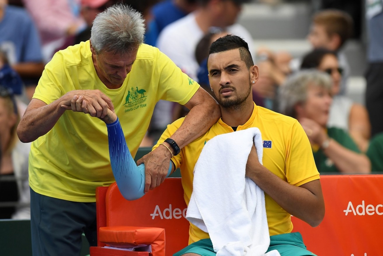 Kyrgios gets his elbow treated during a Davis Cup tie in February.