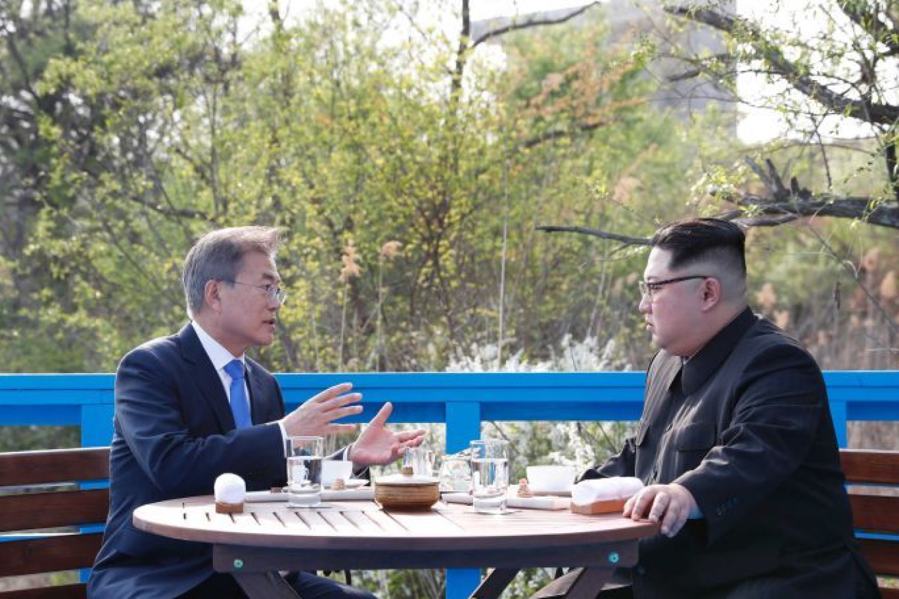 South Korea's Moon Jae In makes a point to Kim Jong Un at their surprise Saturday confab.