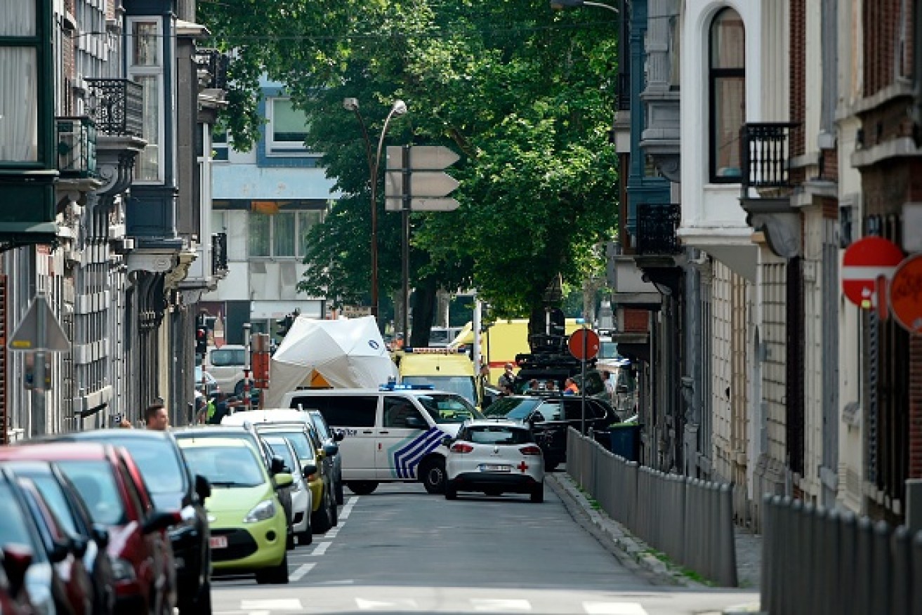 Police secure the site where a gunman shot dead three people, before being killed by elite officers, in the Belgian city of Liege.  