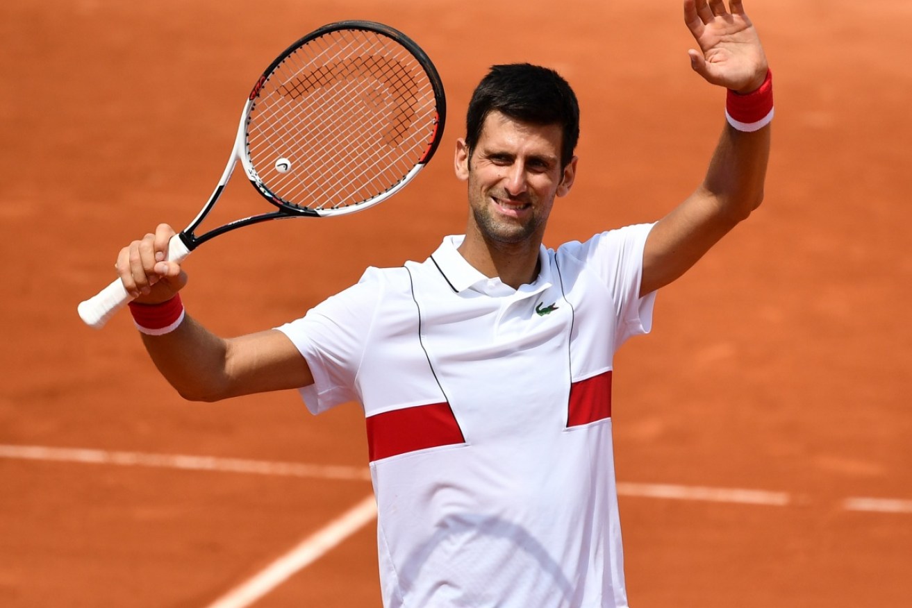 Former champion Novak Djokovic has beaten qualifier Jaume Munar to reach the third round of the French Open.