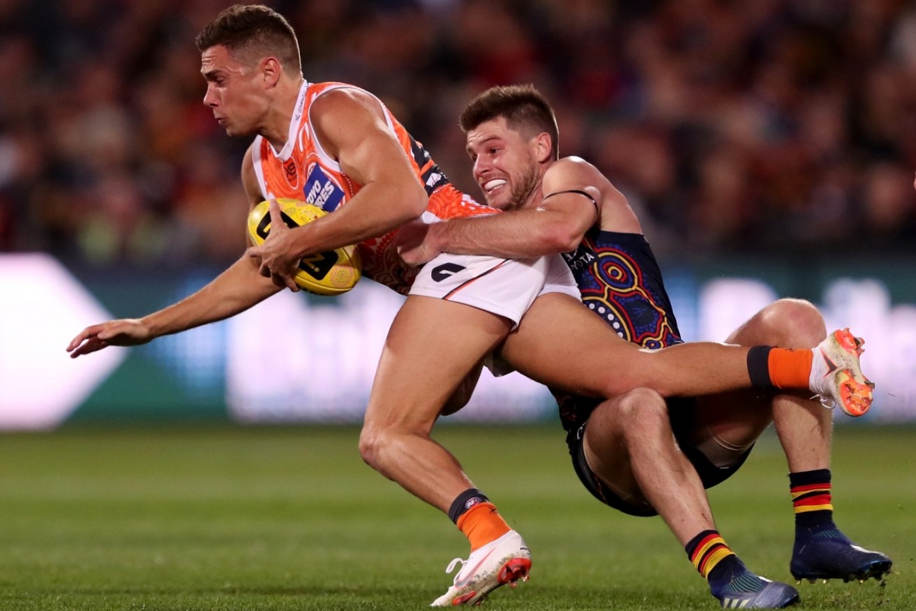 Bryce Gibbs lays a tackle on Josh Kelly in 2018, the year of the infamous camp and Adelaide's dramatic slide down the ladder. <i>Photo: Getty</i>