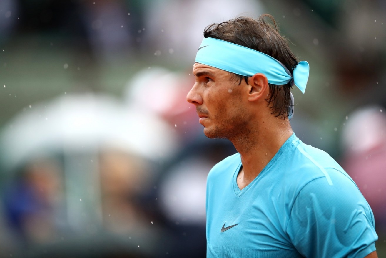 A shock loomed for 10-time champion Rafael Nadal at the French Open before the heavens opened to offer a possible reprieve.