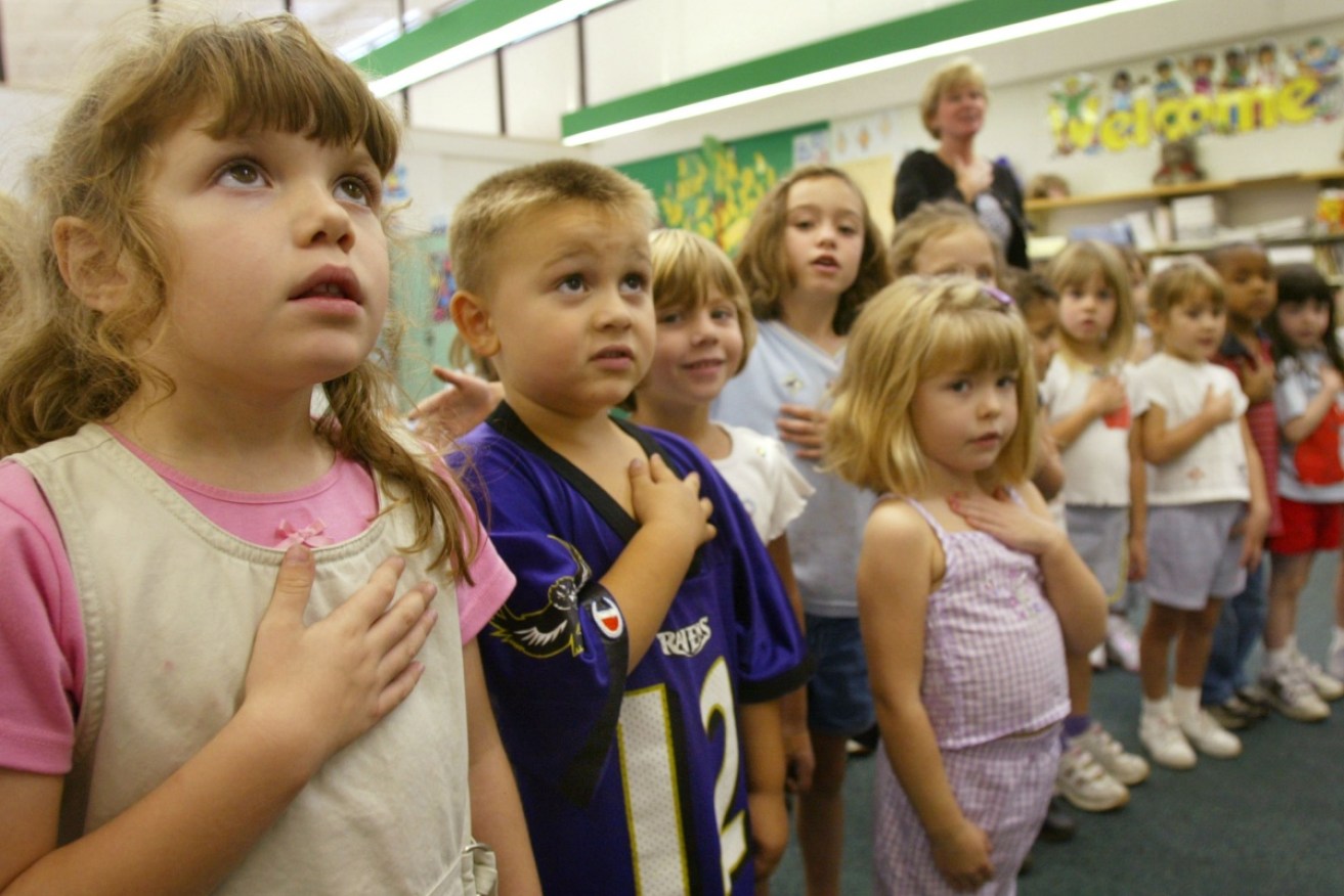 Kindergarten children in the United States are learning the 'Pledge of Alegiance' and a 'Lockdown song' for school shootings. 