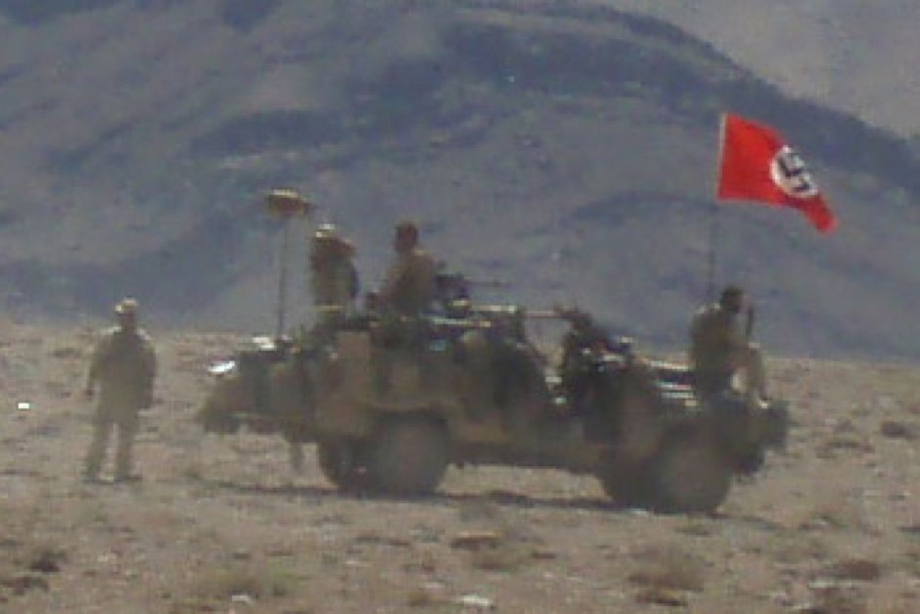 A Nazi swastika flag flies over an Australian Army vehicle in Afghanistan.