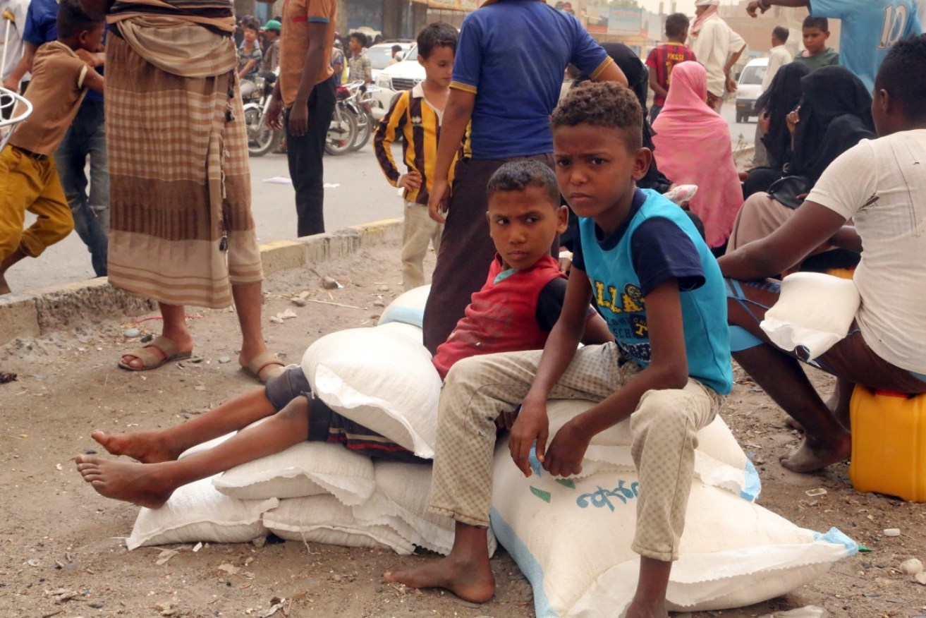 Yemeni children receive food aid in the coastal city of Hodeidah.