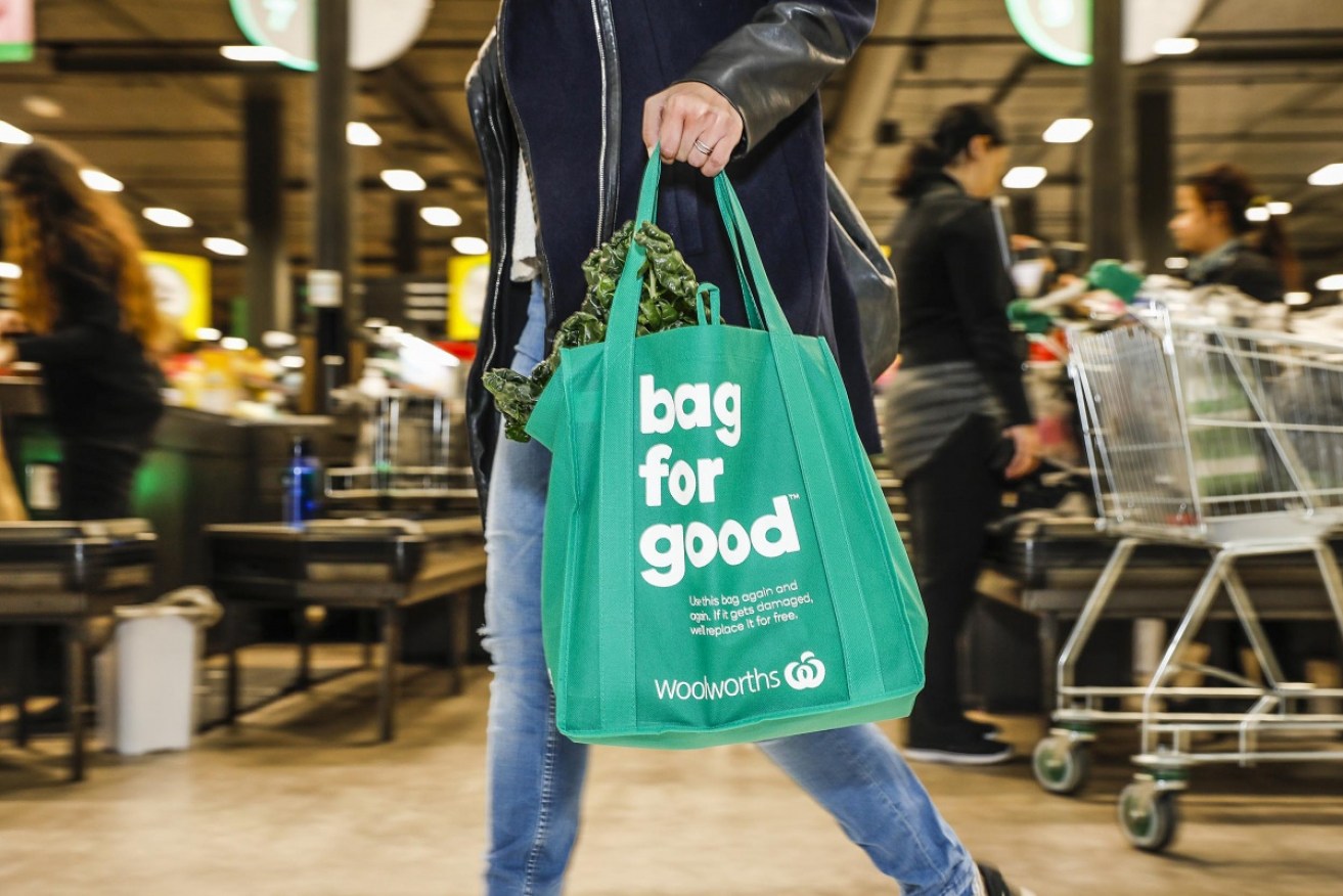Woolworths says getting customers to use reusable plastic bags has been a "challenge".