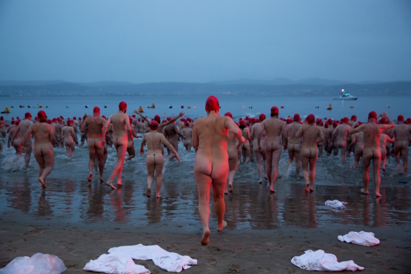 Participants plunge during the Nude Solstice Swim, as part of the Dark Mofo winter festival in the River Derwent.