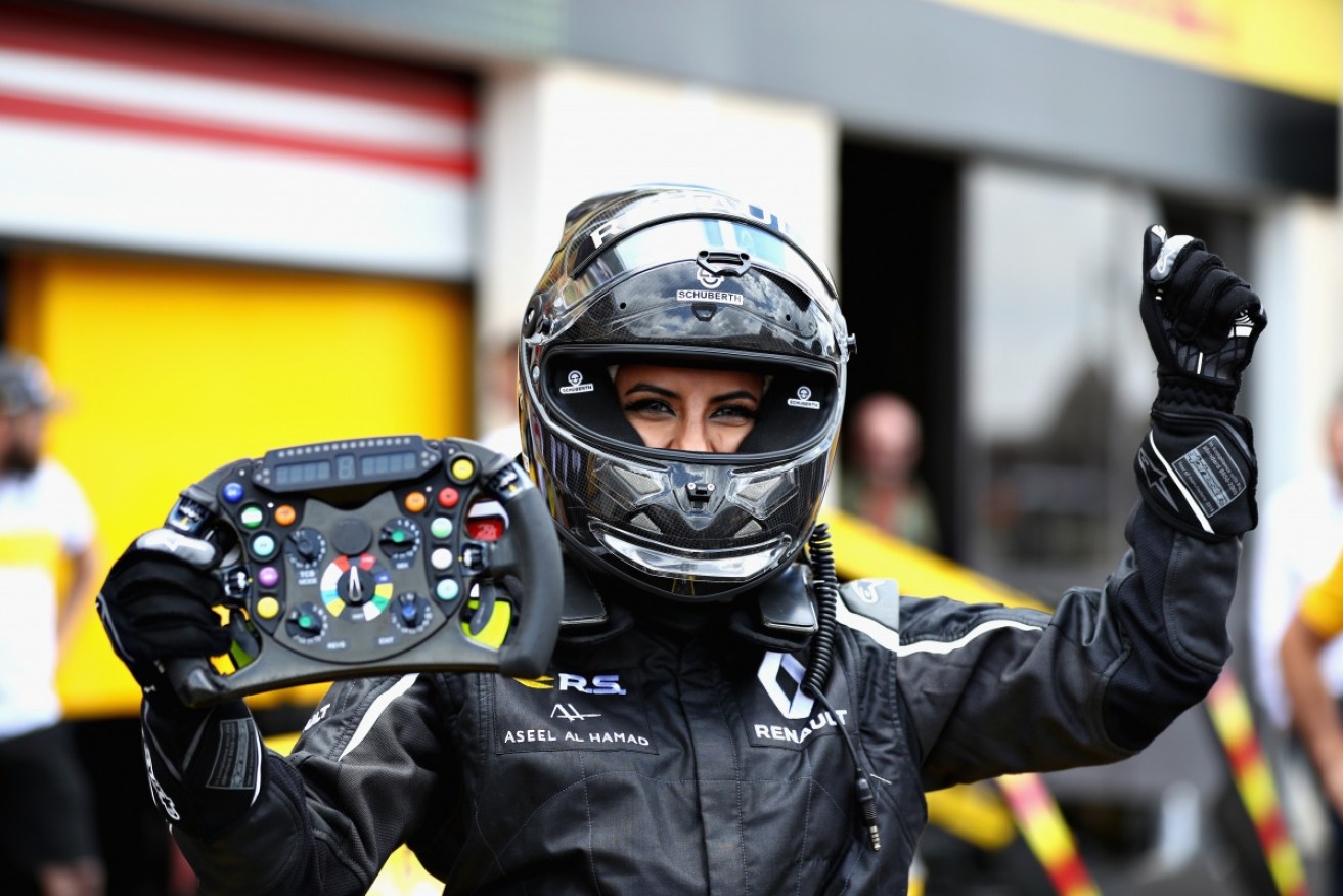 Aseel Al-Hamad poses after driving a 2012 Renault Formula 1 car.