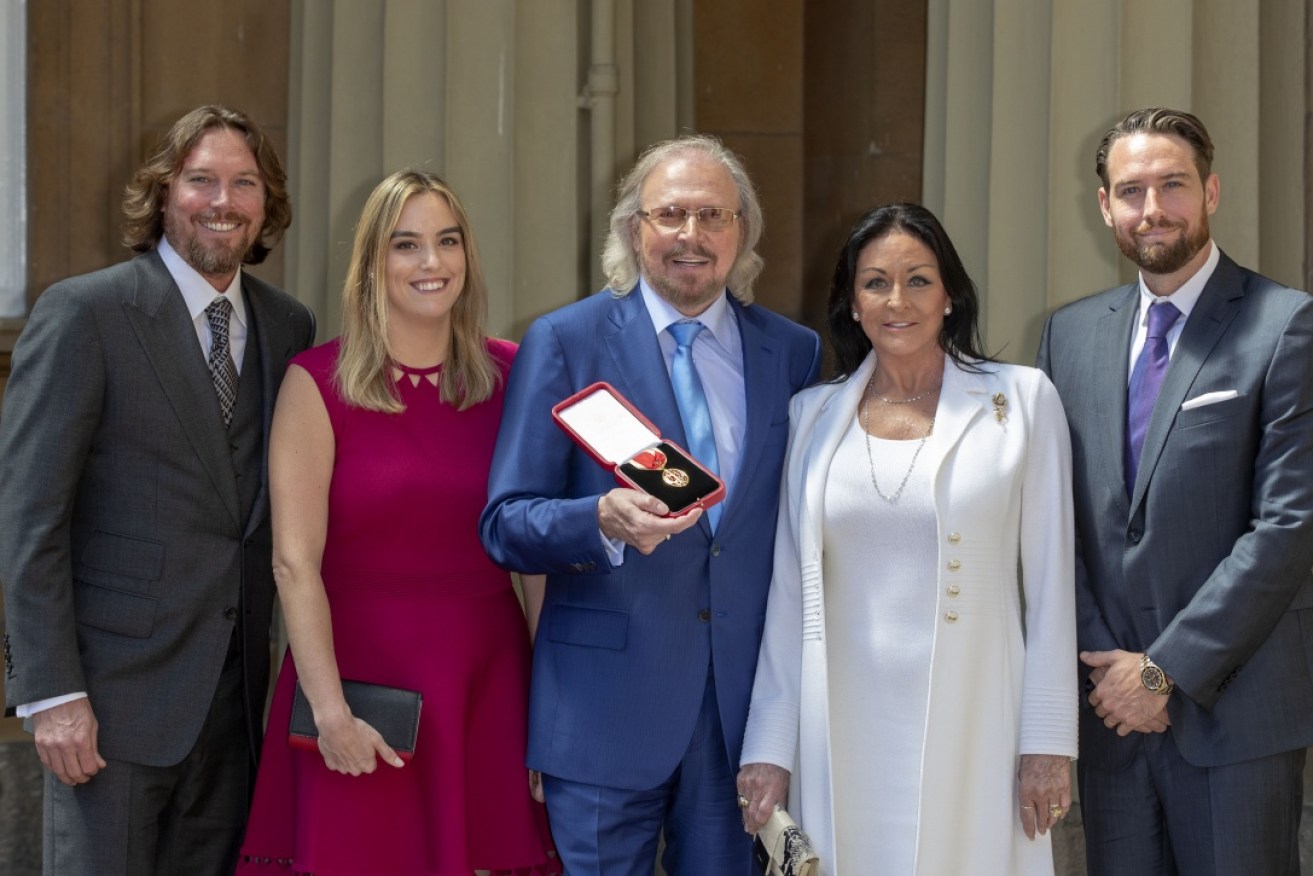 Barry Gibb with his family after he was knighted by the Prince of Wales.
