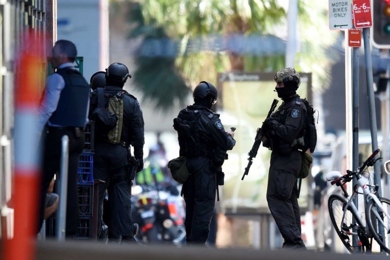 NSW public order and riot squad police gather outside the Lindt Chocolat Cafe during the violent 2014 siege. 