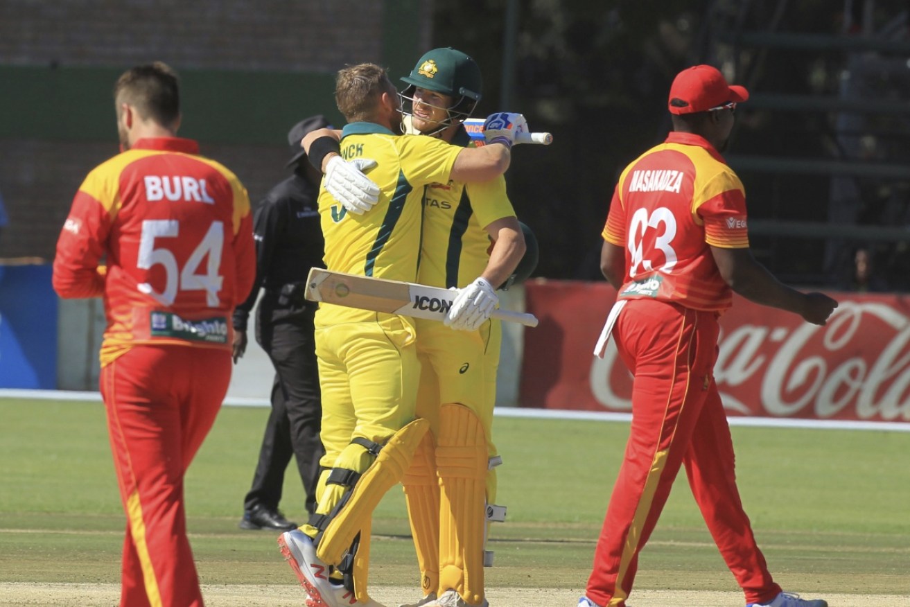 D'Arcy Short congratulates Aaron Finch after his century against Zimbabwe at Harare Sports Club on Tuesday.
