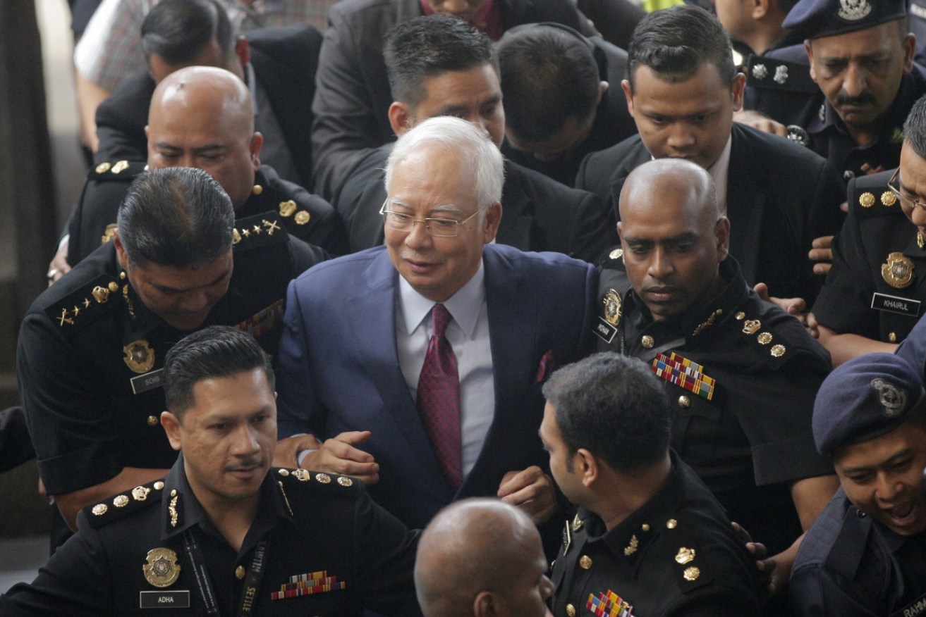 Former Malaysian PM Najib Razak heads into court on Kuala Lumpur.