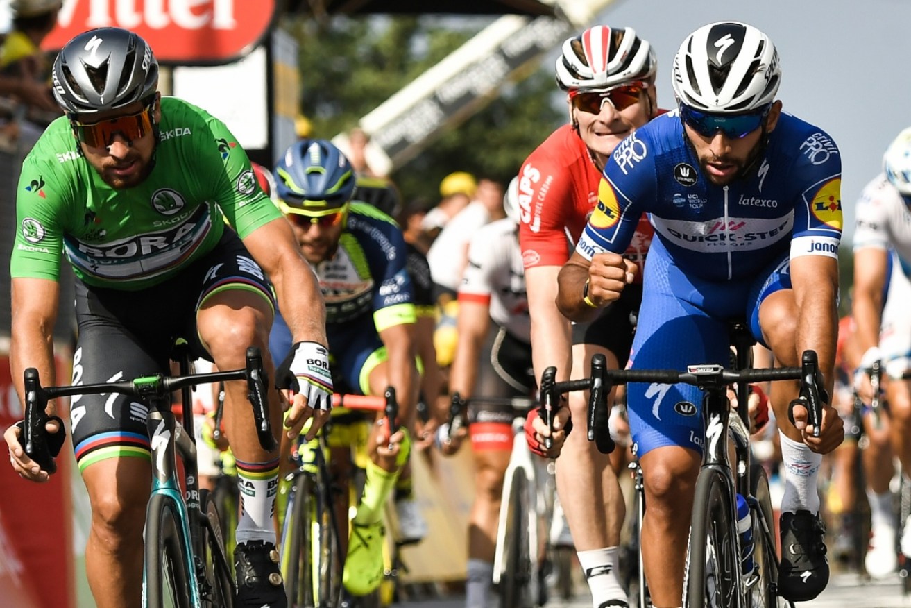 Colombia's Fernando Gaviria (R) reacts after crossing the finish line ahead of Slovakia's Peter Sagan (L) and Germany's Andre Greipel to win the fourth stage