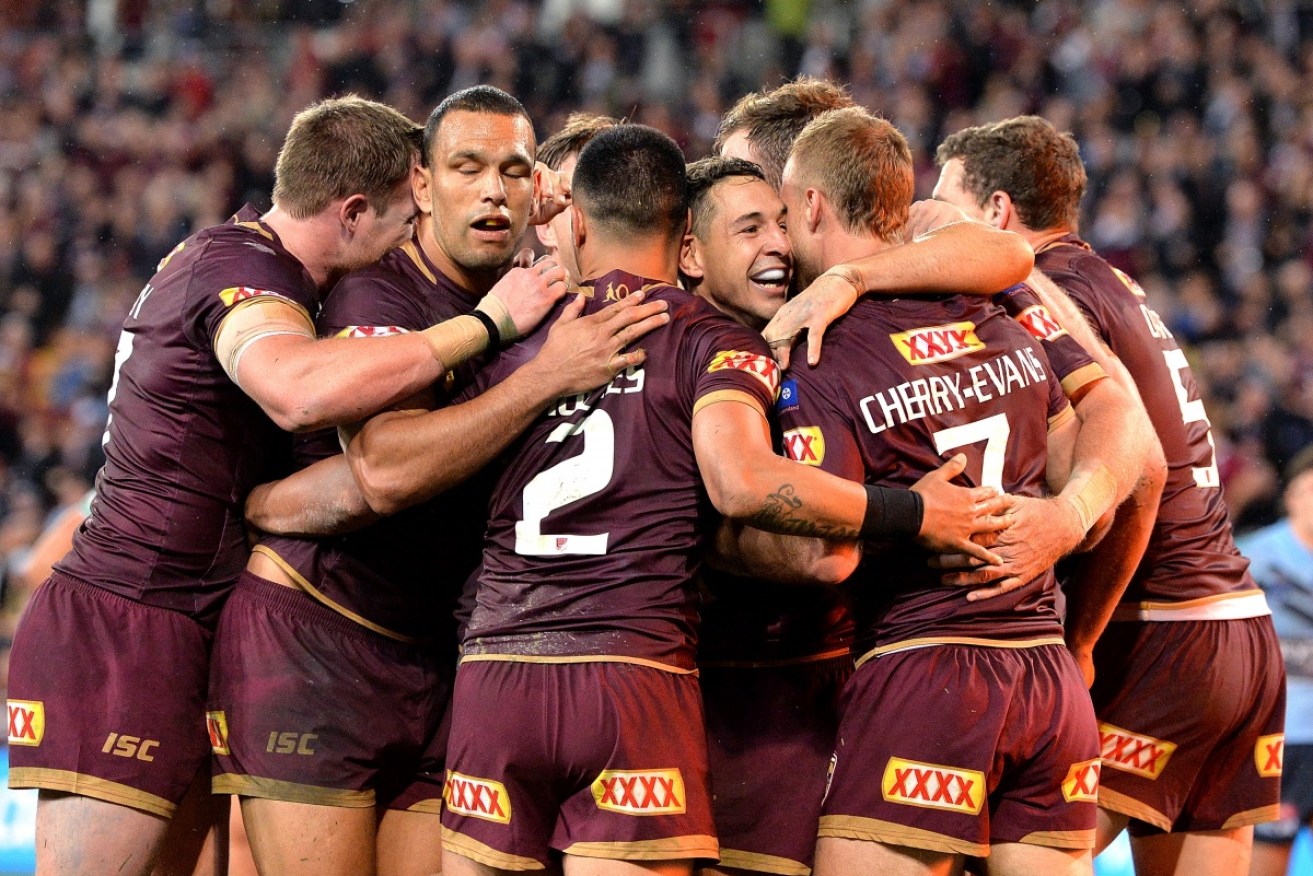 Billy Slater and his Queensland teammates enjoy their 18-12 win.  