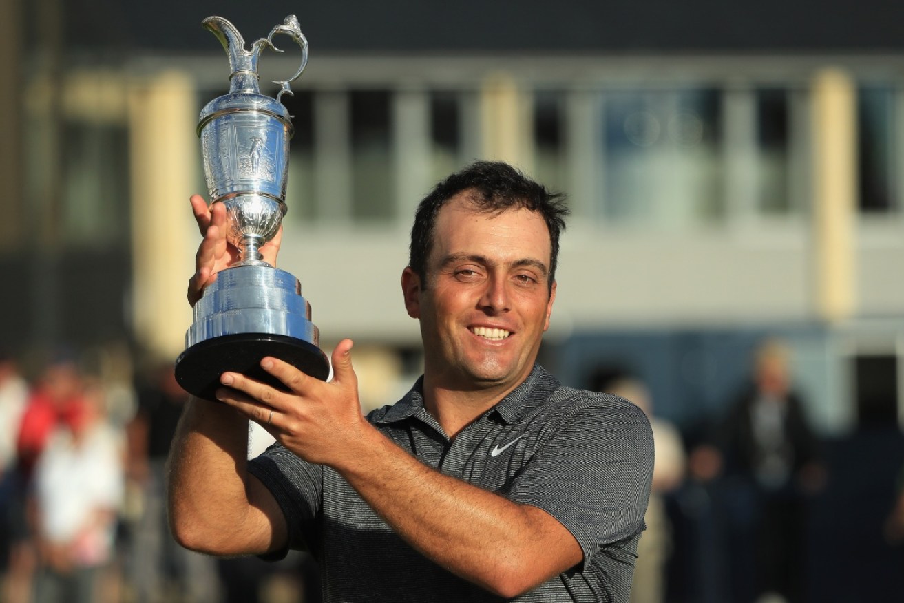 Molinari lifts the famous trophy.