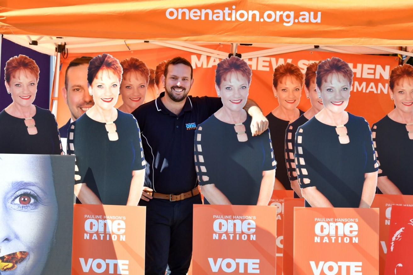 One Nation's Matthew Stephen surrounded by cutouts of his political leader.