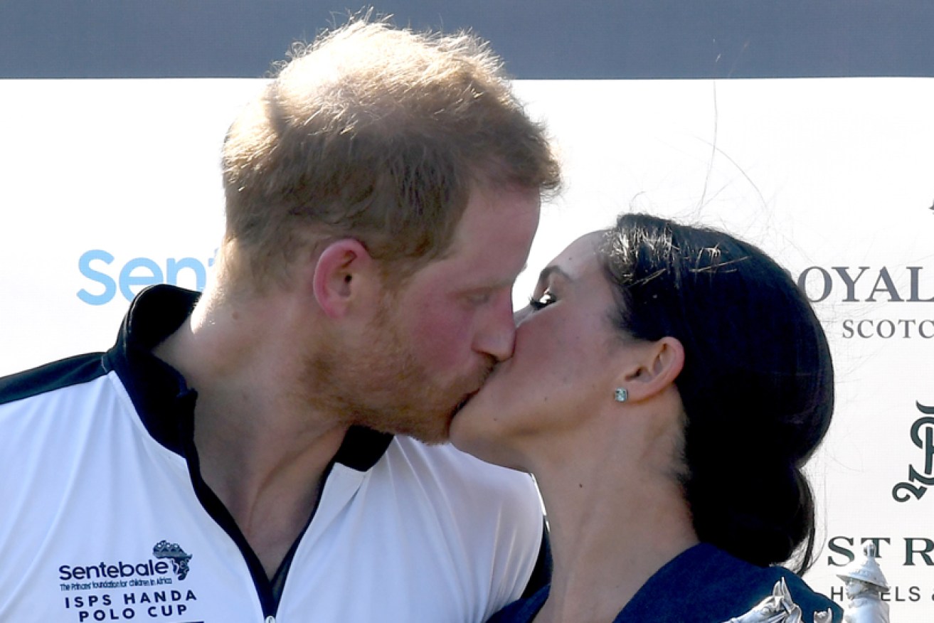 Summer love: The Duke and Duchess of Sussex celebrate at a Windsor polo match on July 26.
