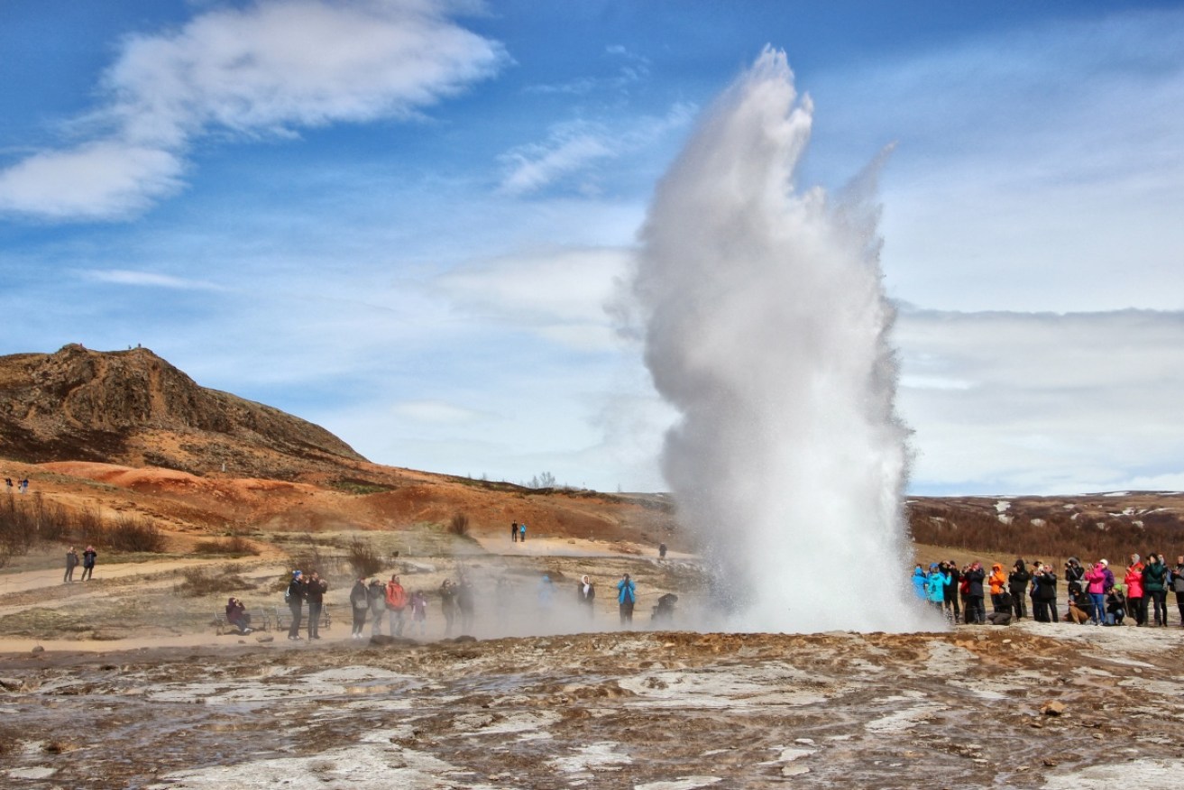 Iceland's Strokkur geyser struts its stuff in front of an adoring crowd. Photo: Getty
