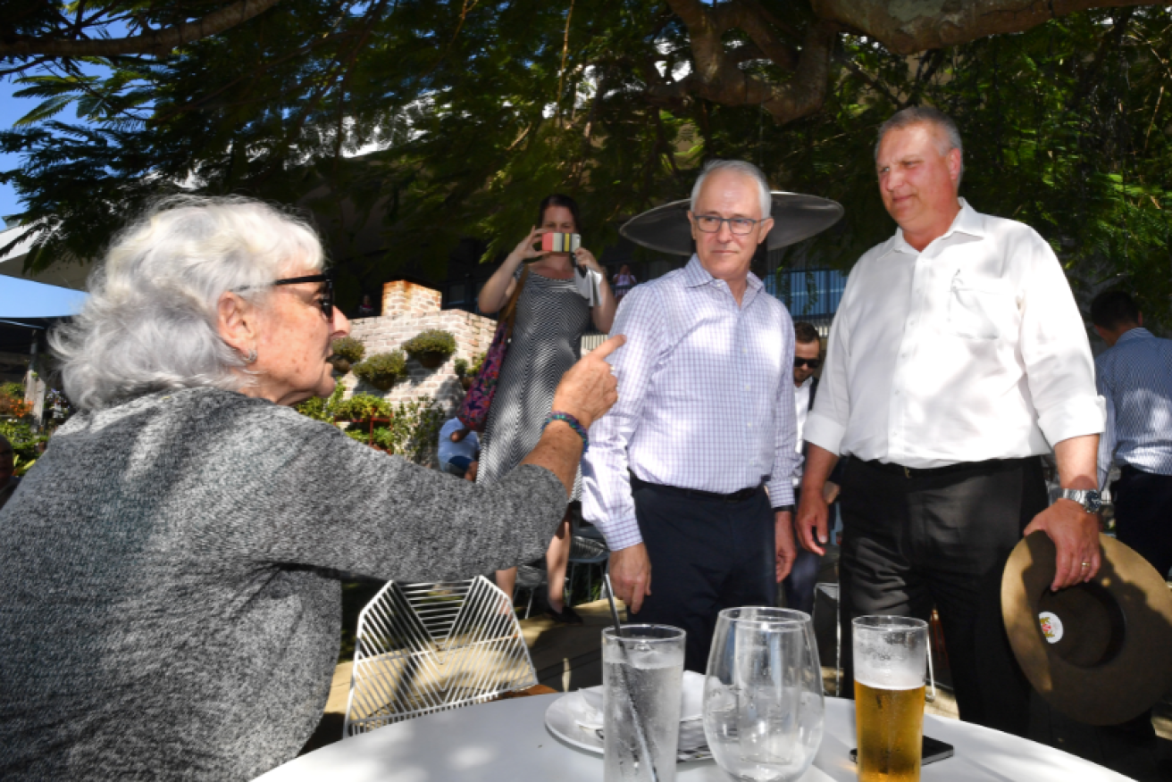 Retired public servant Toni Lea gives the PM and LNP candidate Trevor Ruthenberg a hard time in Longman.