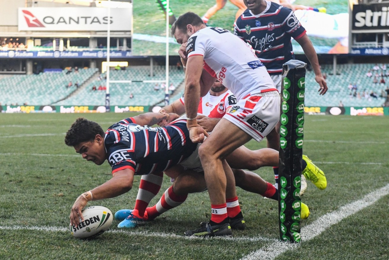 Latrell Mitchell powers over in the corner to open the Roosters' scoring on Sunday.  