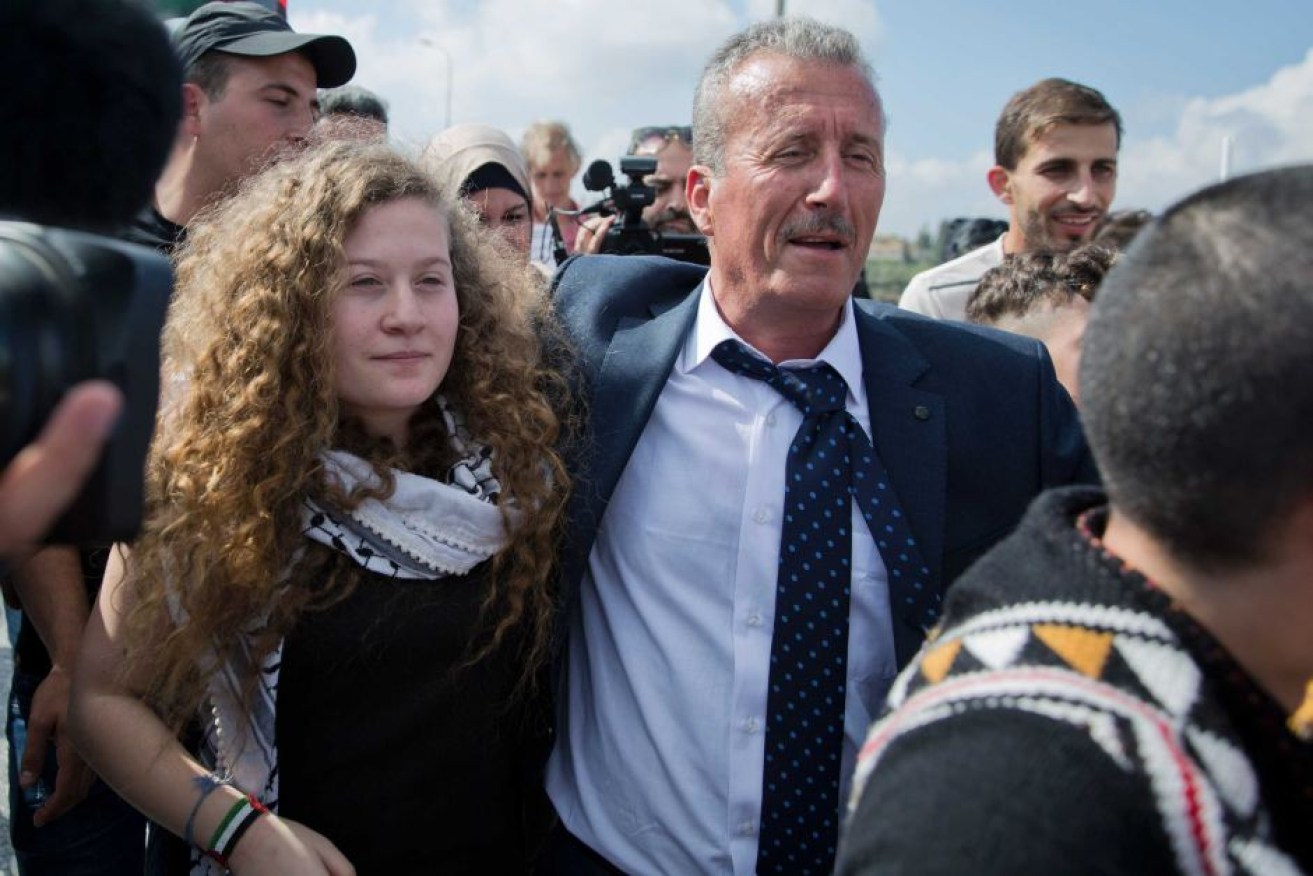 Ahed Tamimi and her father Bassem arrive at their village after her release.