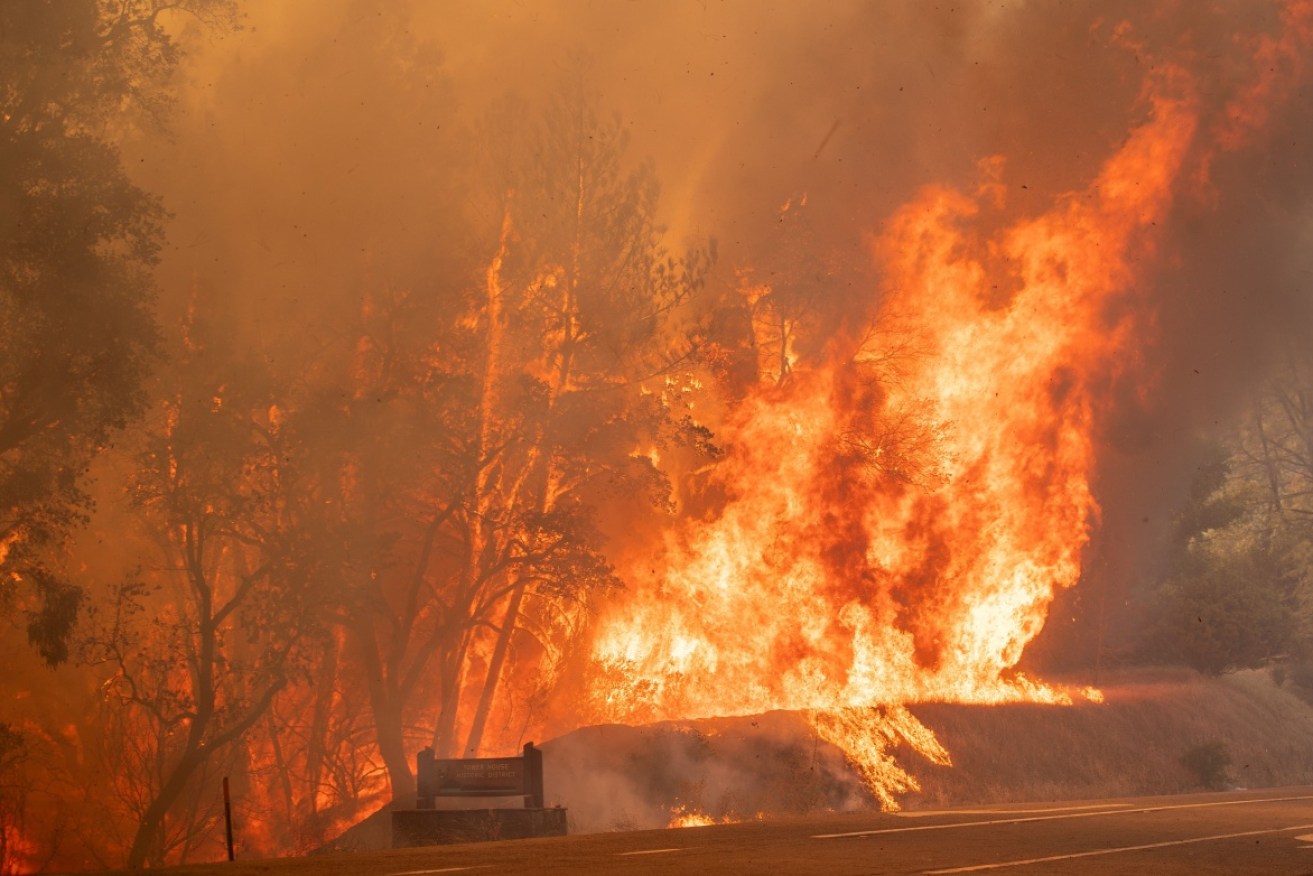 Two firefighters have died as wildfires continue to raze California.